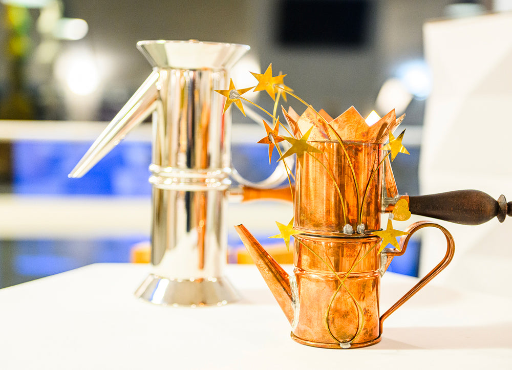 Shiny copper and silver teapots with star decorations on display at Courmayeur Design Weekend 2024.