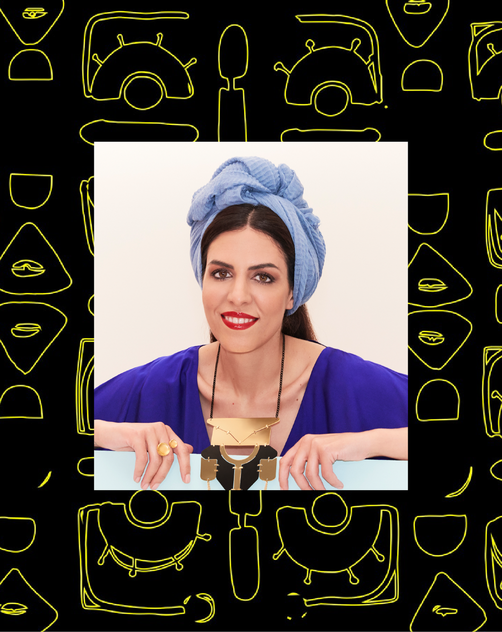 Woman in blue turban and bold jewelry smiles confidently against a vibrant yellow patterned background.