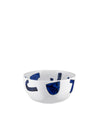 White ceramic bowl by Alessi with bold, dark blue abstract shapes, front view.