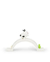 White goat ornamental figurine with black spots by Alessi, standing on a white arch base decorated with a yellow flower and green sprout.