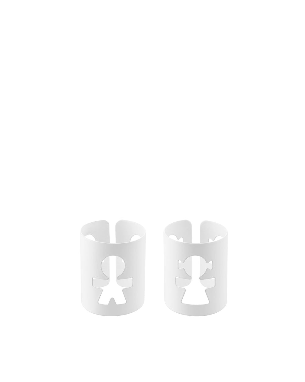 Two white napkin holders by Alessi, featuring playful cut-out boy and girl figures.