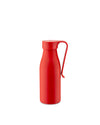 Red thermo insulated bottle by Alessi, featuring a curved handle and matte finish on white.