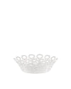 White decorative fruit holder by Alessi with an intricate openwork pattern of connected stylized figures.