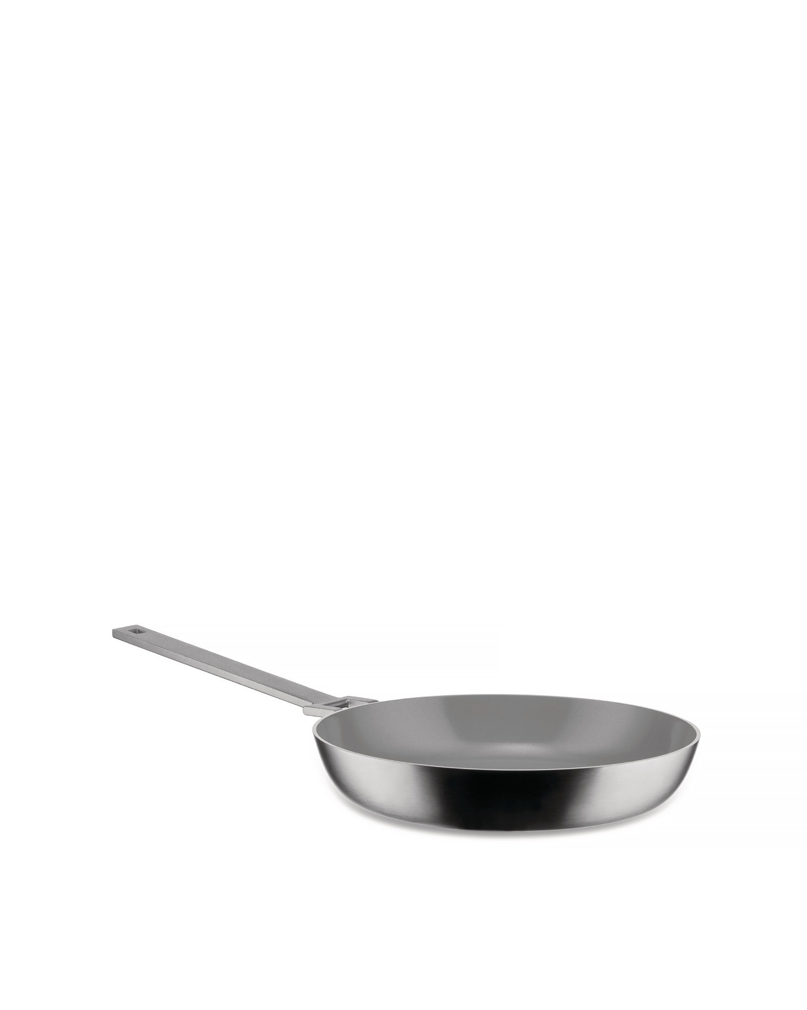 Silver frying pan by Alessi with a grey non-stick interior and long handle, angled view.