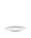 White dining plate by Alessi with a blue geometric zigzag pattern around the rim.