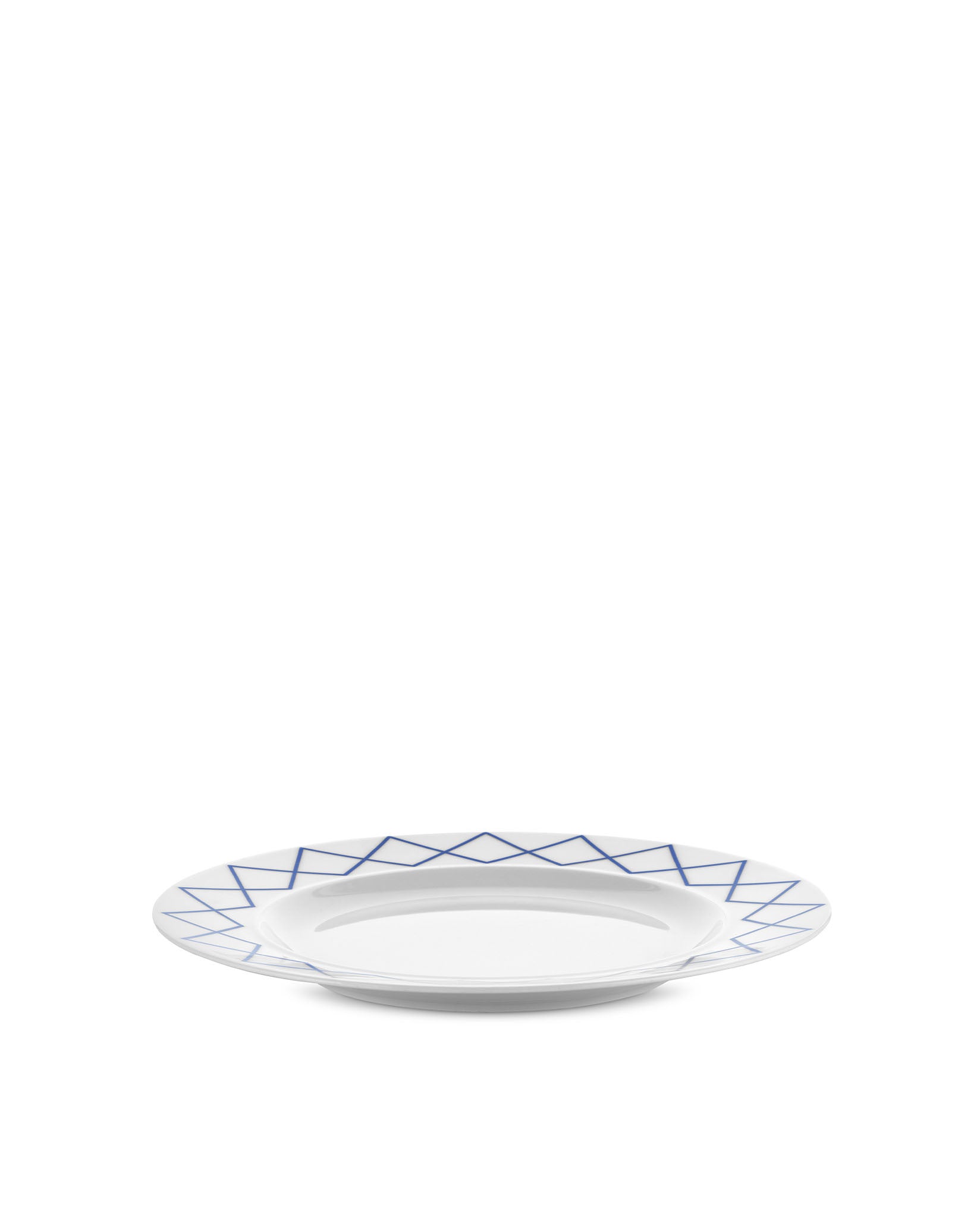 White dining plate by Alessi with a blue geometric zigzag pattern around the rim.