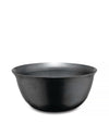 Black metal bowl by Alessi, featuring subtle horizontal ridged texture and a wide rim.