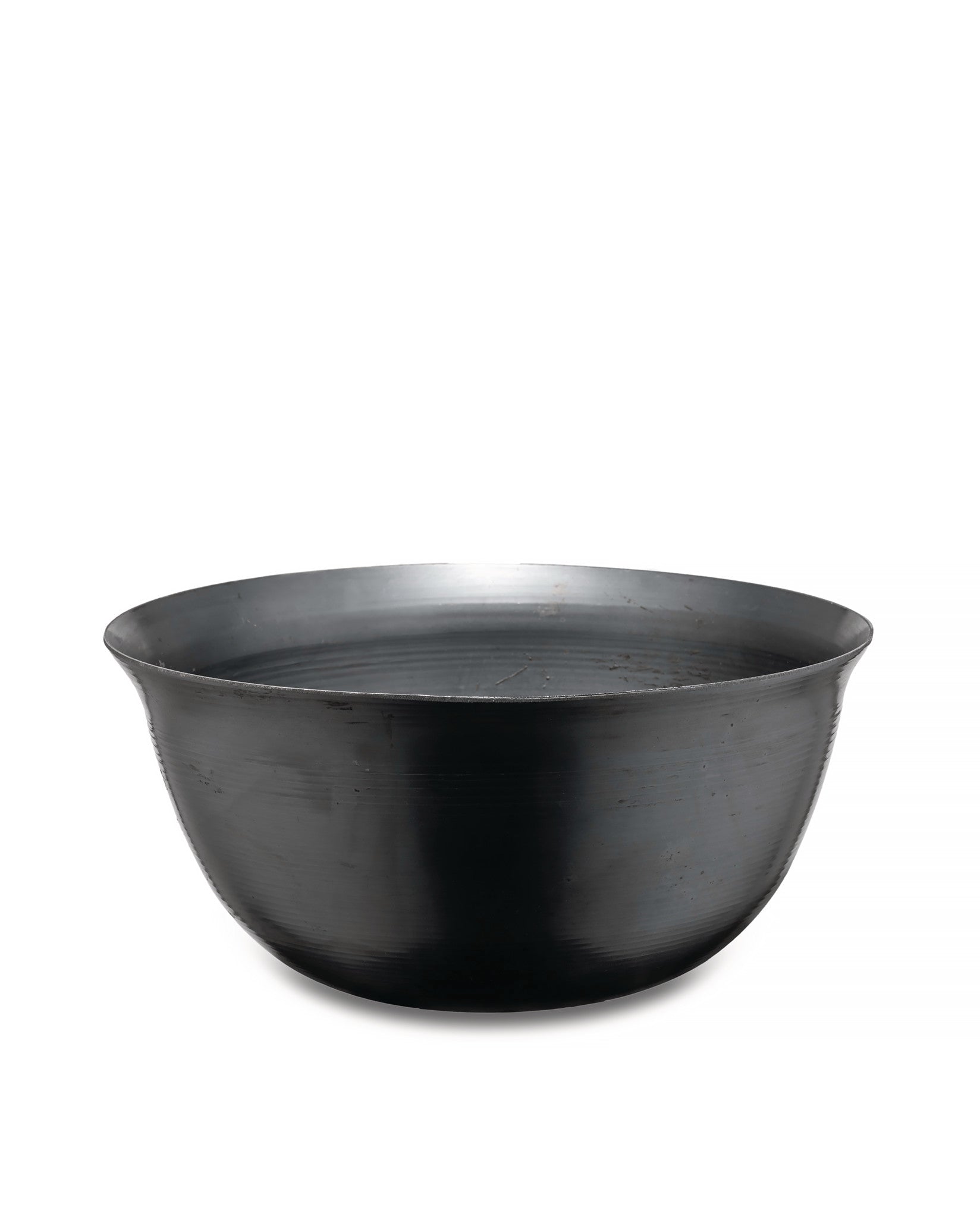 Black metal bowl by Alessi, featuring subtle horizontal ridged texture and a wide rim.