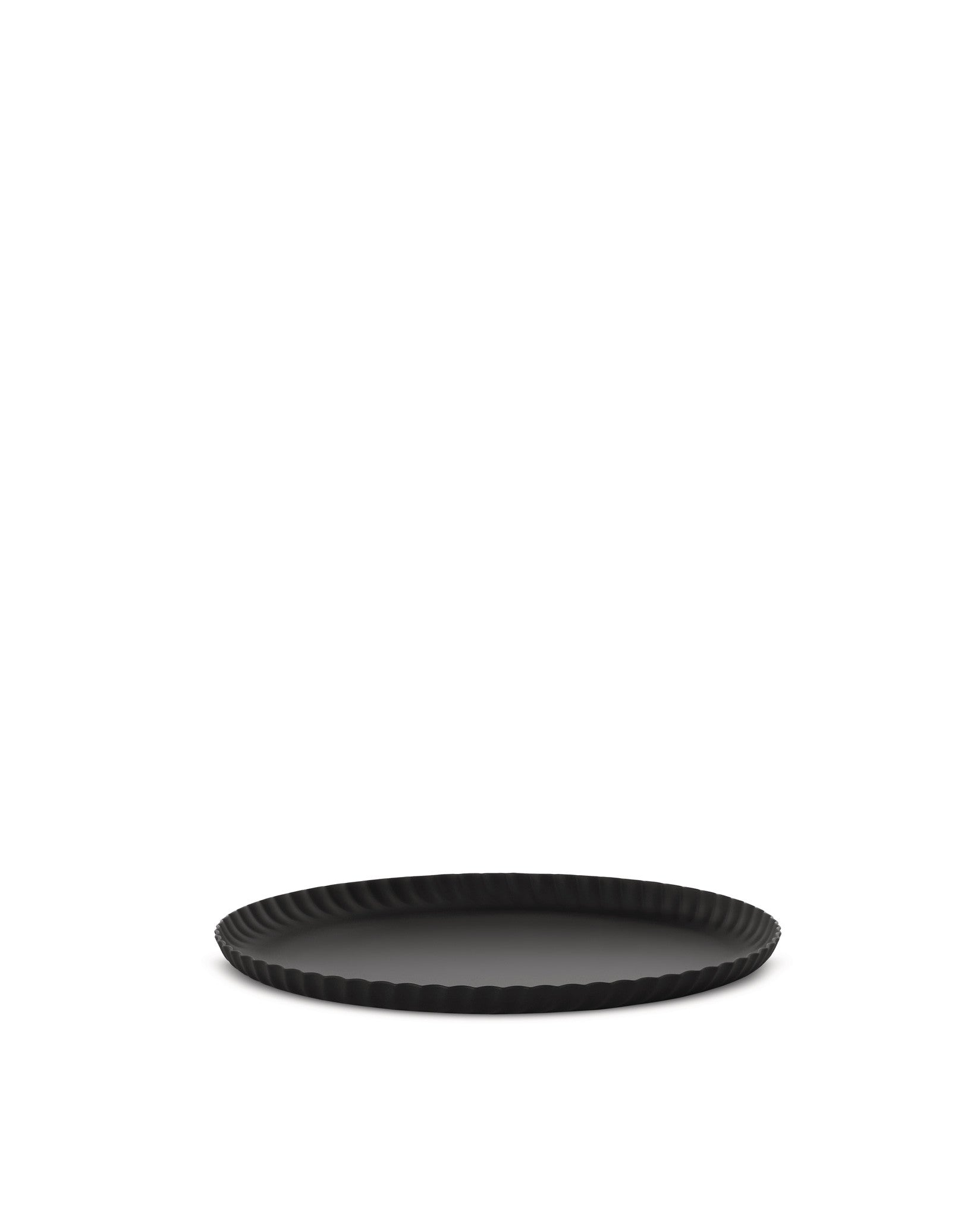 Black round tray by Alessi with a distinctive fluted edge, viewed at an angle.