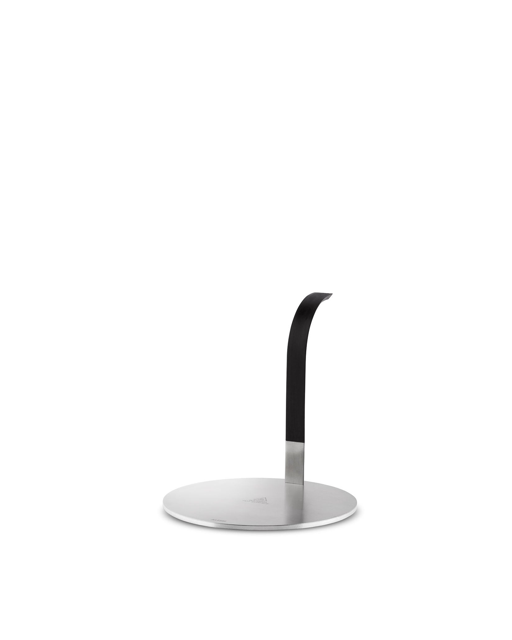 Stainless steel paper towel holder by Alessi with a round base and a matte black, curved upright arm.