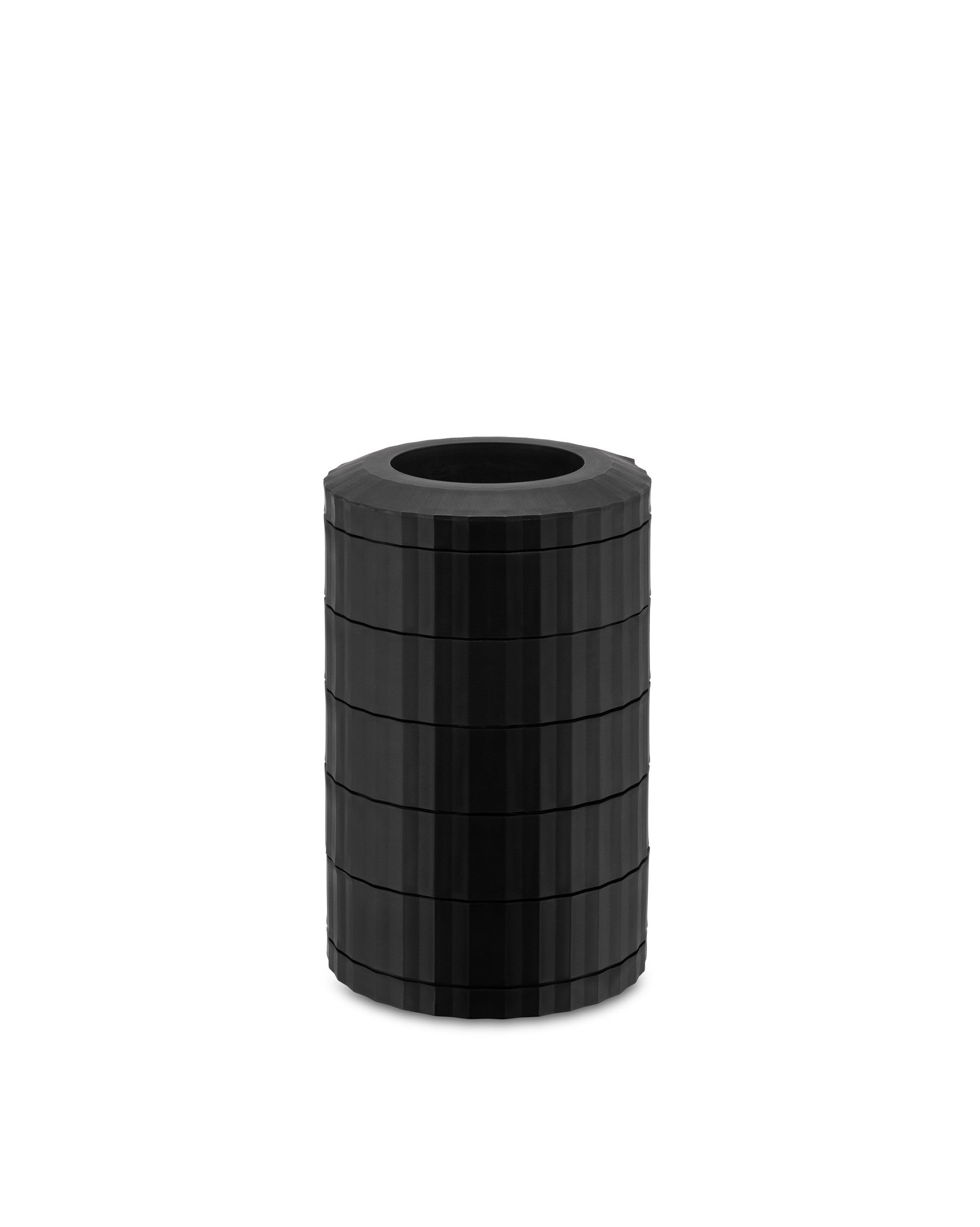 Black cylindrical capsule holder by Alessi with vertical plissé texture and stacked segments.