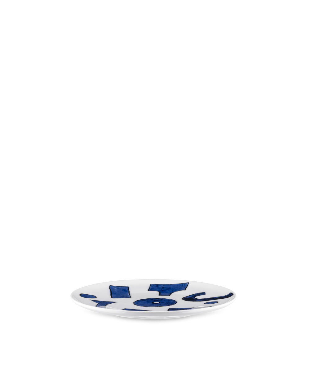 Small white ceramic dish by Alessi, featuring abstract blue patterns, viewed at a slight angle.