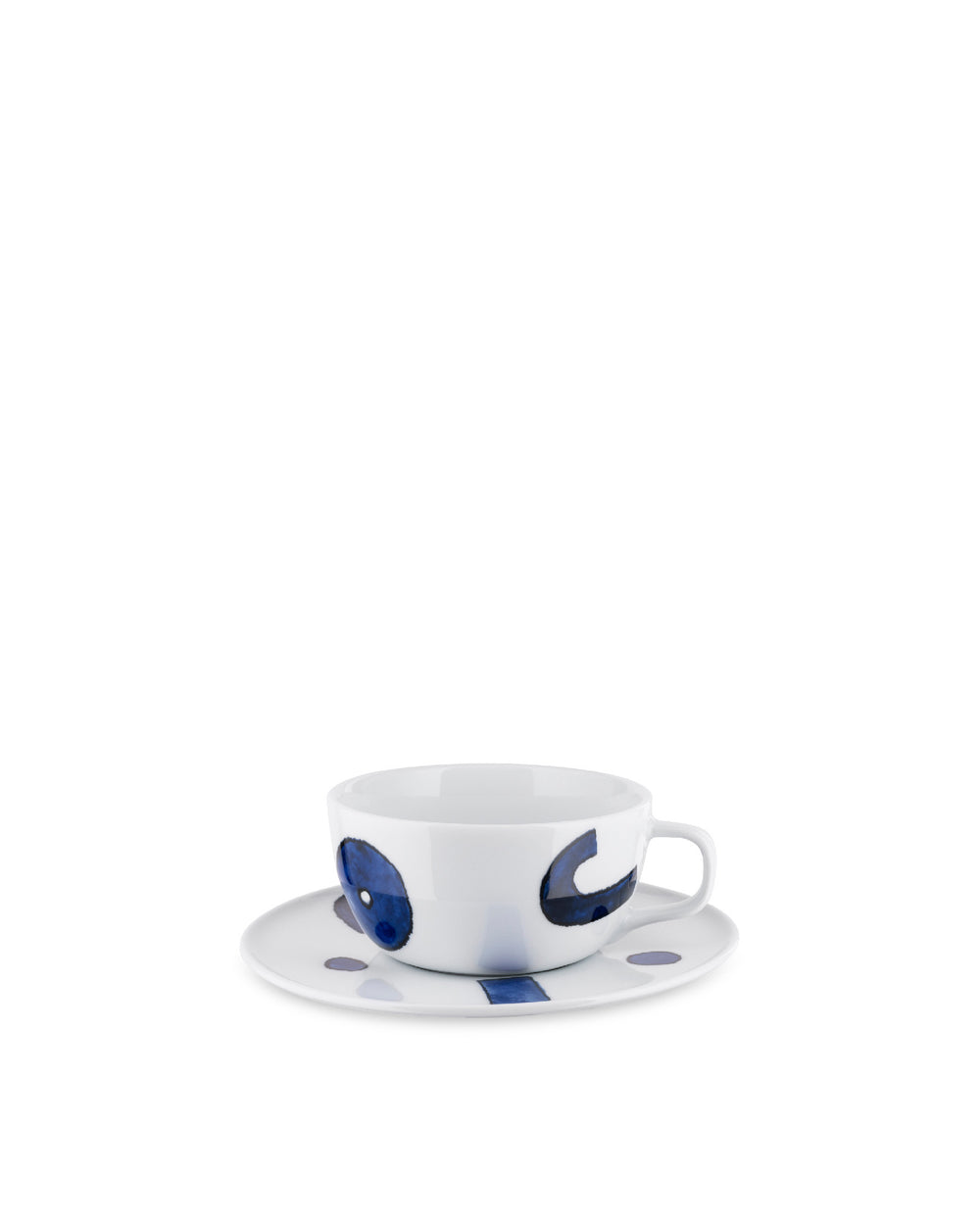 White cup and saucer set by Alessi, with dark blue abstract brushstroke patterns and dots.