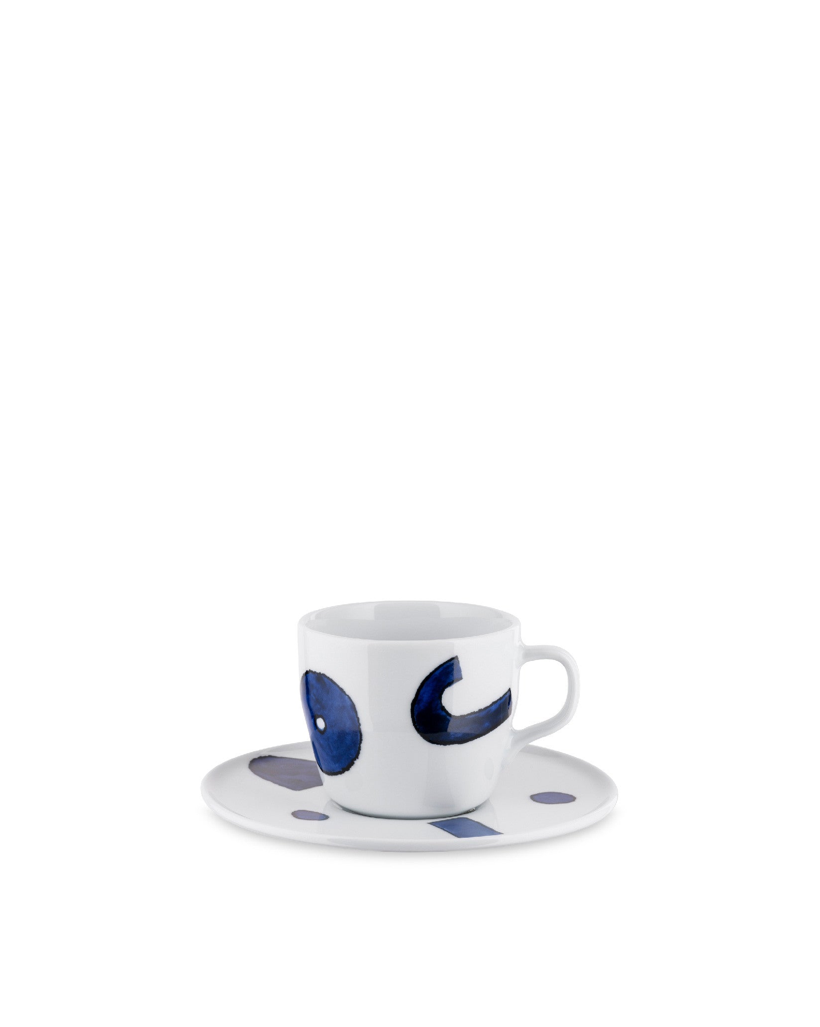 White ceramic coffee cup and saucer by Alessi with abstract blue shapes: a circle and curved form on the cup, and smaller shapes on the saucer.