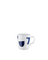 White ceramic mug by Alessi featuring dark blue abstract shapes, including a '7', seen from the side.