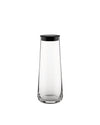 Clear glass pitcher by Alessi with a sleek black lid, standing upright.