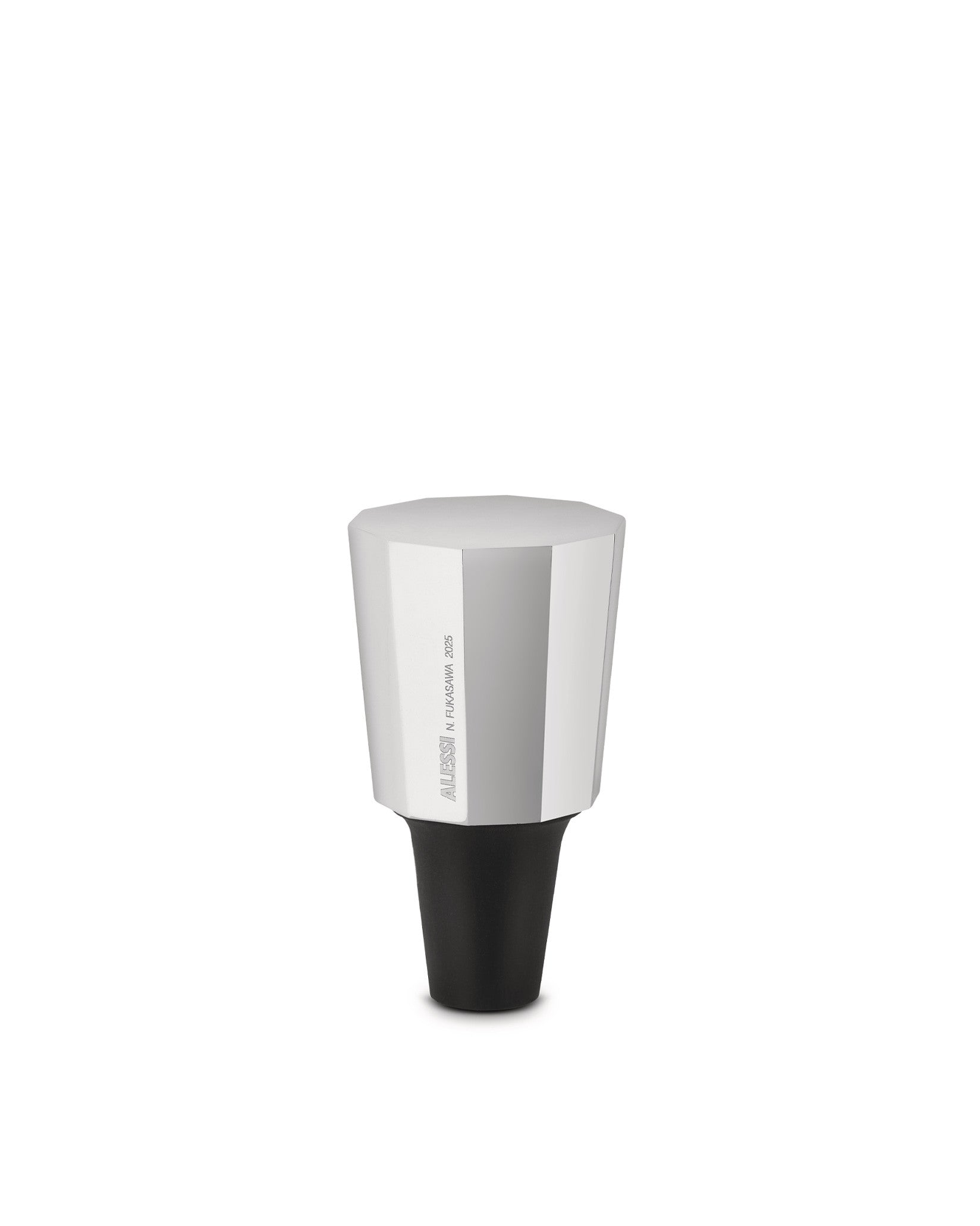 Silver and black hexagonal stopper by Alessi with a black conical base and engraved text.