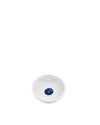 White ceramic pet bowl by Alessi with a dark blue eye design in the center.