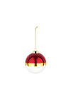 Red and white glass Christmas tree ornament by Alessi, with a scalloped gold band, glossy red top, and white bottom, suspended by a gold chain.