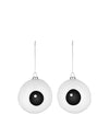 Two white eyeball Christmas tree ornaments by Alessi, hanging from silver chains.