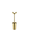Gold toilet brush by Alessi with a sculptural, two-pronged handle and matching cylindrical holder.