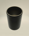 Dark grey matte cylindrical cup by Alessi, featuring a subtle rim highlight, viewed from above.