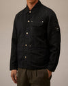 Black utility jacket by Alessi with light snap buttons, an embroidered chest logo, and a circular sleeve patch.