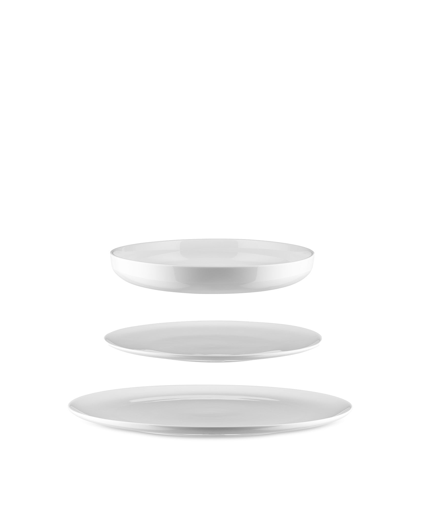 White ceramic table set by Alessi featuring a shallow bowl and two plates floating vertically.