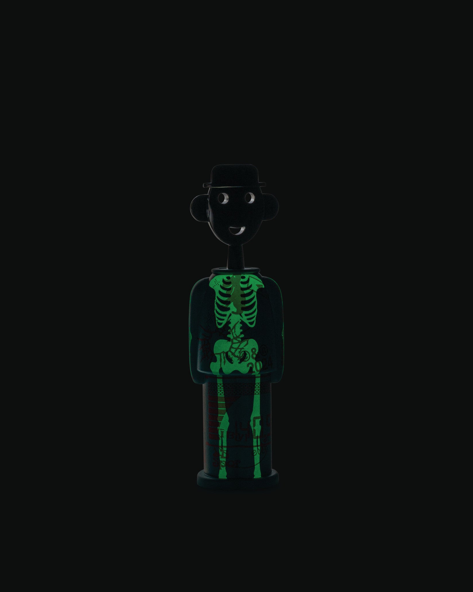 Black corkscrew with a glow-in-the-dark skeleton design by Alessi, styled as a smiling person wearing a hat.