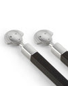 Two brushed stainless steel and dark wood sushi sticks by Alessi, featuring smiling character faces.