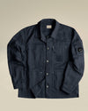 Navy blue crinkled utility jacket by Alessi, with button closure and visible C.P. Company logos.