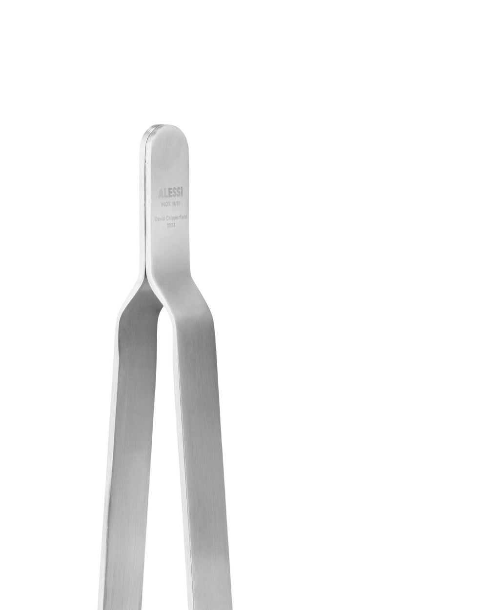 Silver brushed metal kitchen tongs by Alessi, engraved with 'INOX 18/10' and 'David Chipperfield 2023', cropped view.