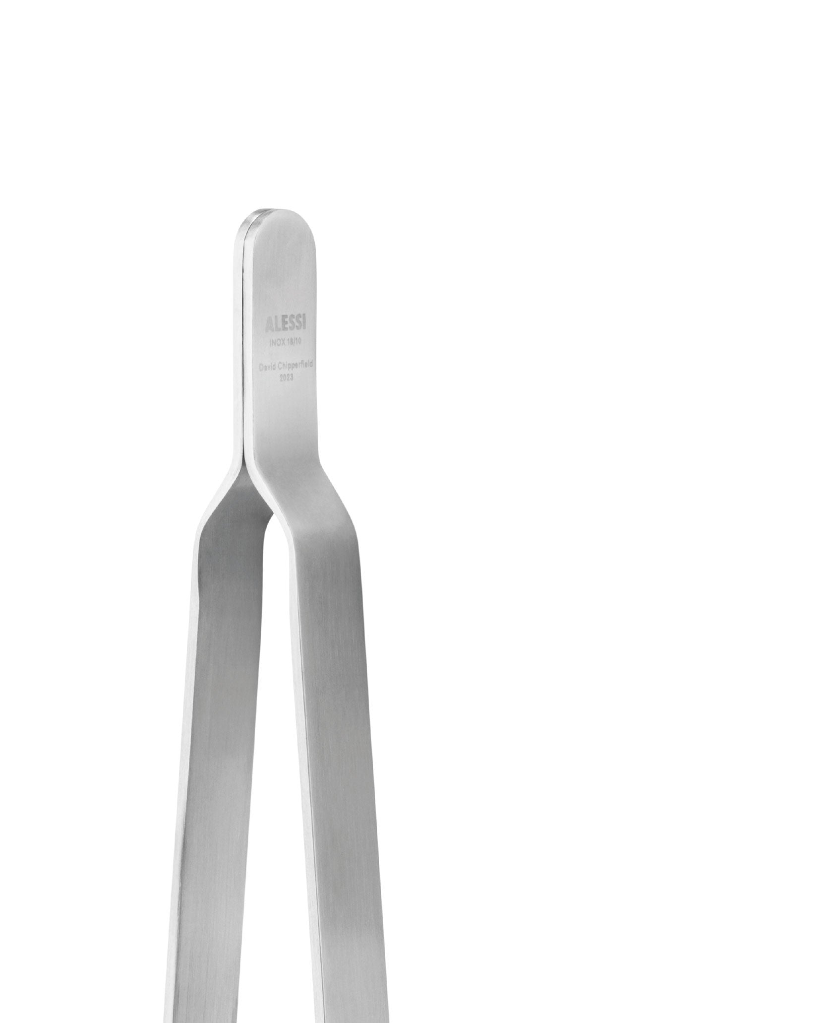 Silver brushed metal kitchen tongs by Alessi, engraved with 'INOX 18/10' and 'David Chipperfield 2023', cropped view.