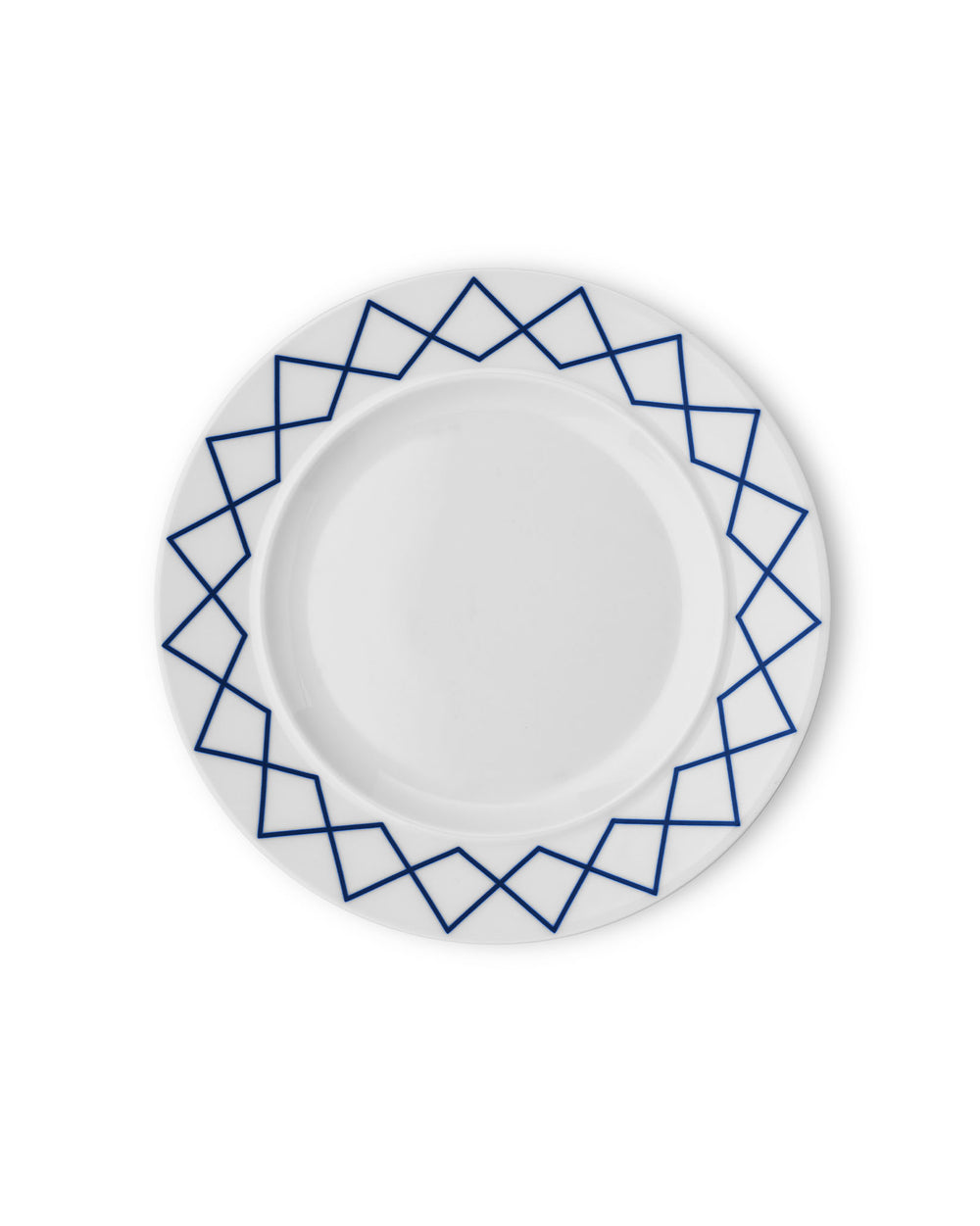 White ceramic dining plate by Alessi with a blue geometric zigzag pattern on the rim, from a top-down view.