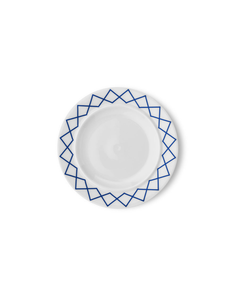 White side plate by Alessi with a blue geometric pattern along the rim, viewed from above.
