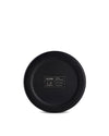 Black stainless steel cup by Alessi, showing the matte bottom with engraved design and brand details.