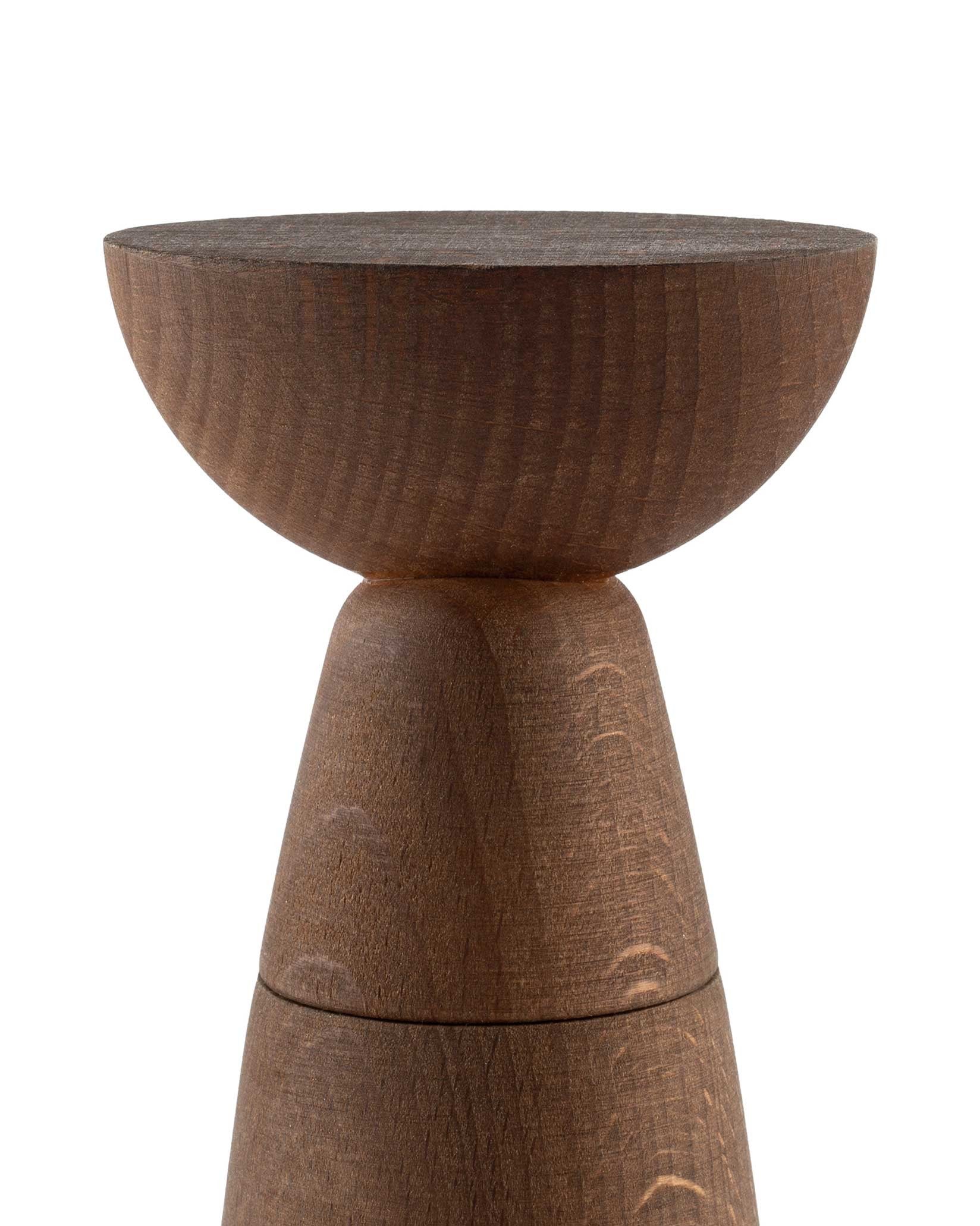 Dark brown wooden salt, pepper and spice grinder by Alessi, featuring a bowl-shaped top and textured, stacked conical body.