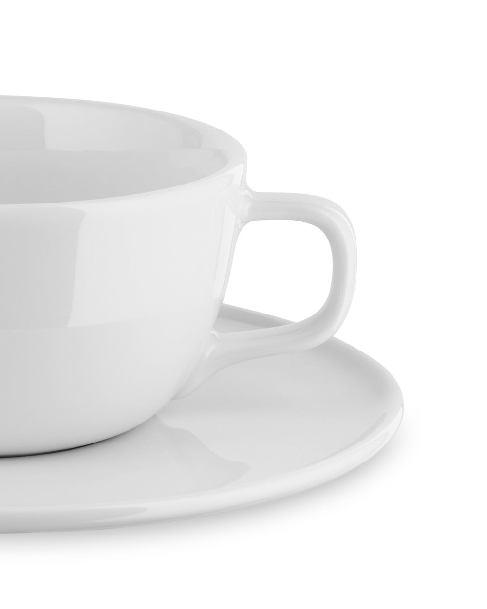 A white glossy cup and saucer by Alessi, shown in a cropped side view with a simple handle.