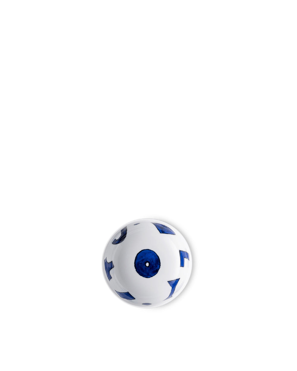White ceramic bowl by Alessi with abstract blue shapes and a central blue circle, top-down view.