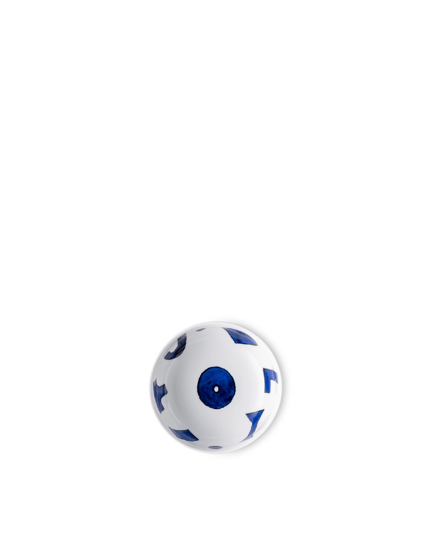 White ceramic bowl by Alessi with abstract blue shapes and a central blue circle, top-down view.