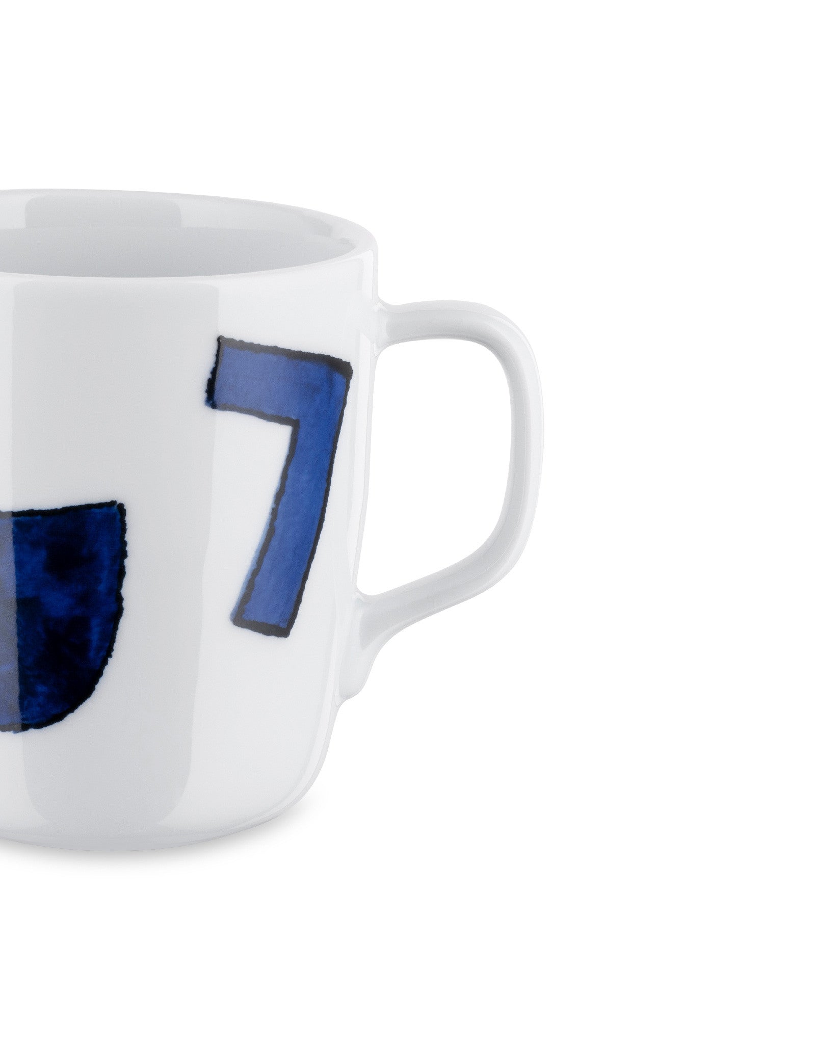 White ceramic mug by Alessi with a hand-painted blue number 7 and a partial blue design, cropped side view.