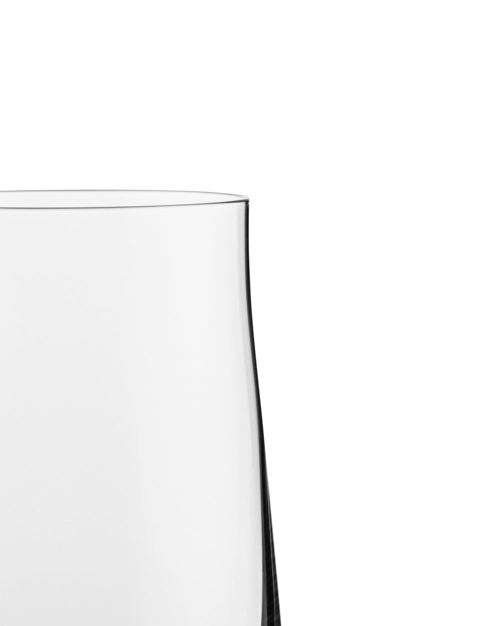 Clear long drink glass by Alessi, showing the smooth, slightly tapered rim and side in a close-up.