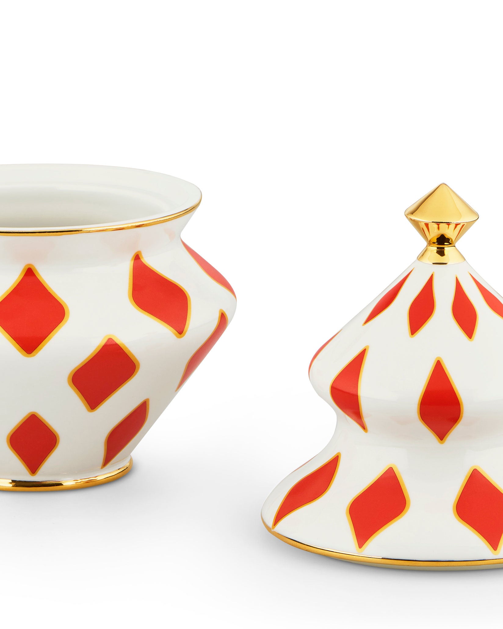 White ceramic Christmas container by Alessi with red diamond patterns, gold trim, and a separate pointed gold lid.