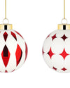 Red and white spherical Christmas tree ornaments by Alessi, one with diamond patterns, the other with star patterns, hanging from gold chains.