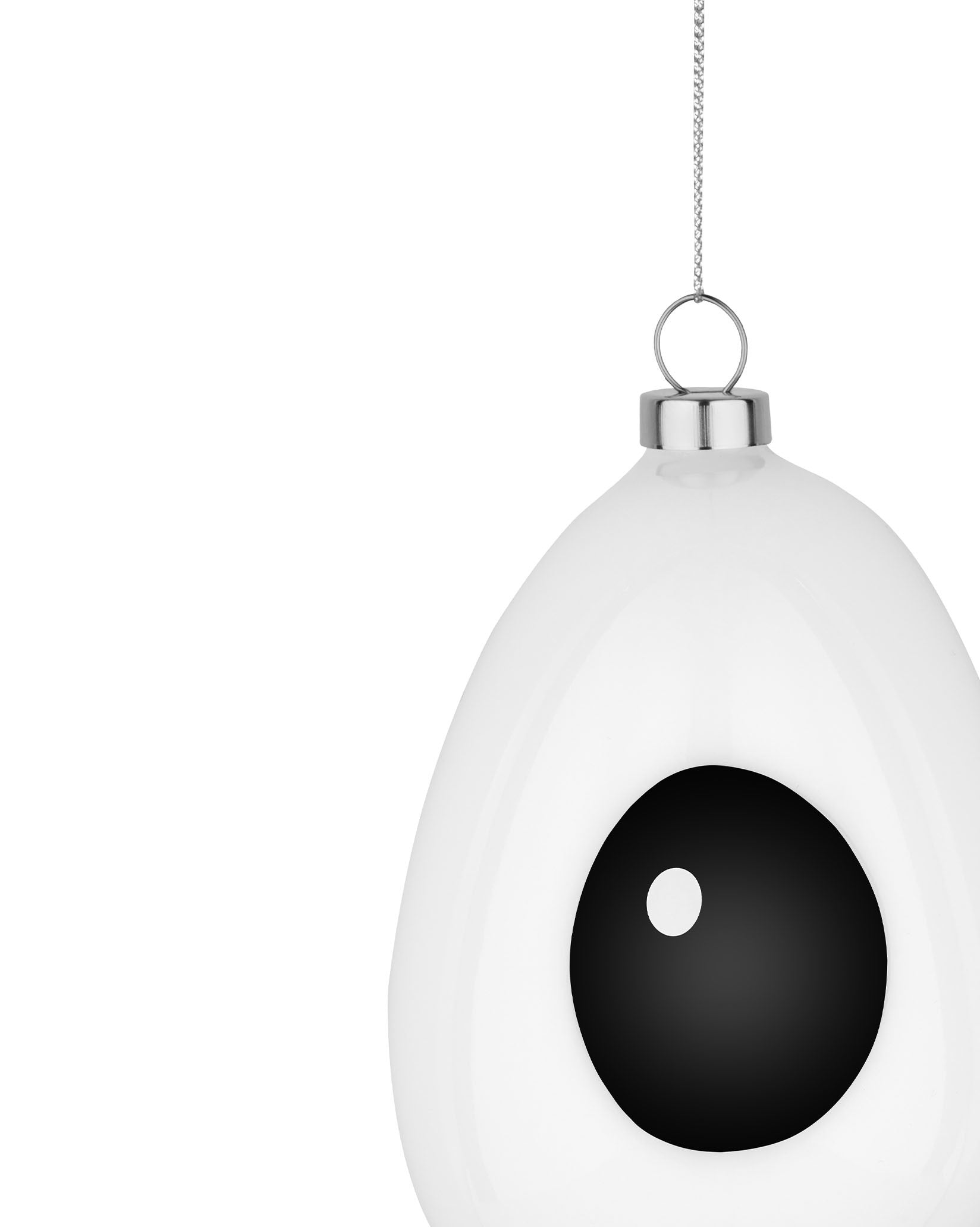 White egg-shaped ornament by Alessi, featuring a black eye design and silver chain.