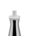 Silver and white oil cruet by Alessi with a sleek, reflective, hourglass-shaped body and a white cylindrical top.