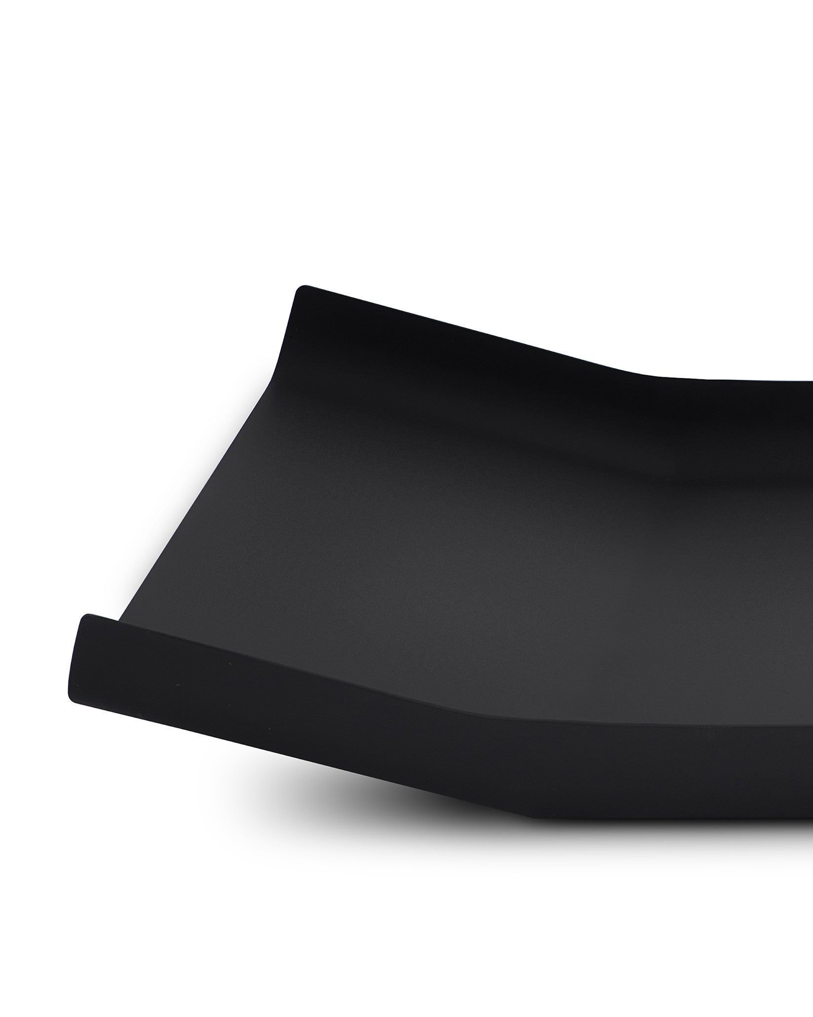 Black matte tray by Alessi with a sleek, curved design, shown from an angled view.