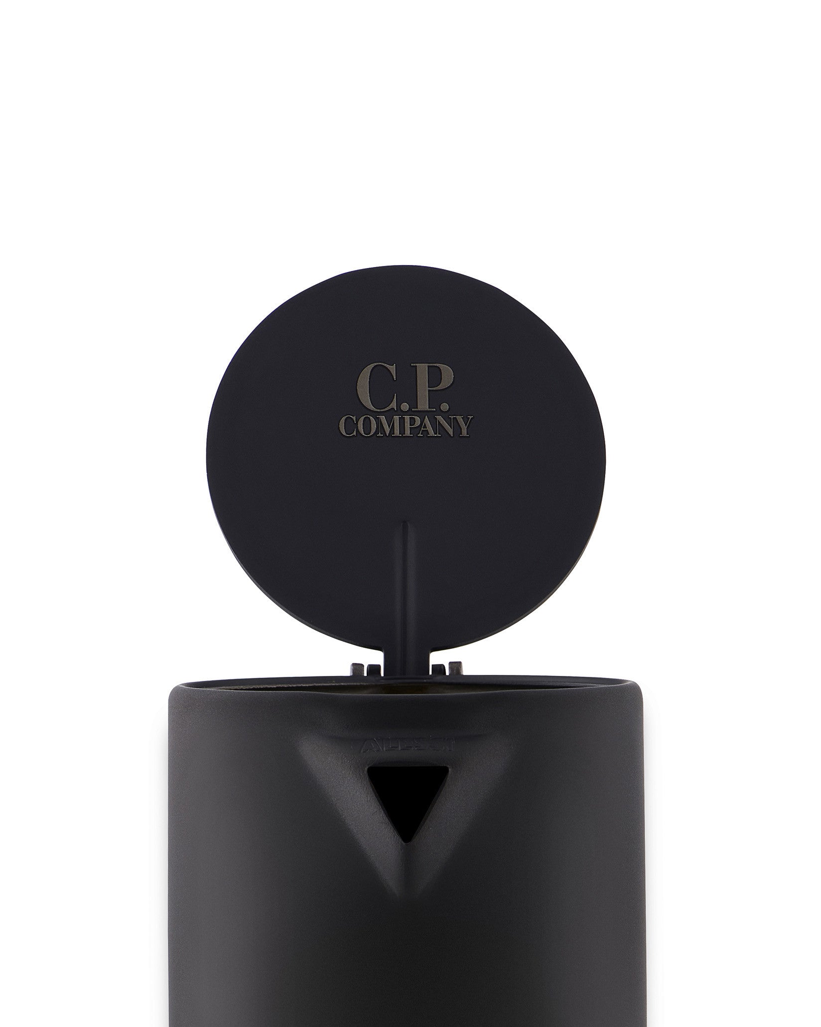 Black matte metal espresso coffee maker by Alessi with an open circular lid engraved with 'C.P. COMPANY', featuring 'ALESSI' subtly embossed near the spout.