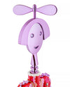 Metallic purple Anna G. corkscrew by Alessi with a smiling face, dragonfly wings, and red and pink patterned base.
