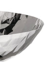 Silver faceted bowl by Alessi with a geometric crumpled design, close-up.